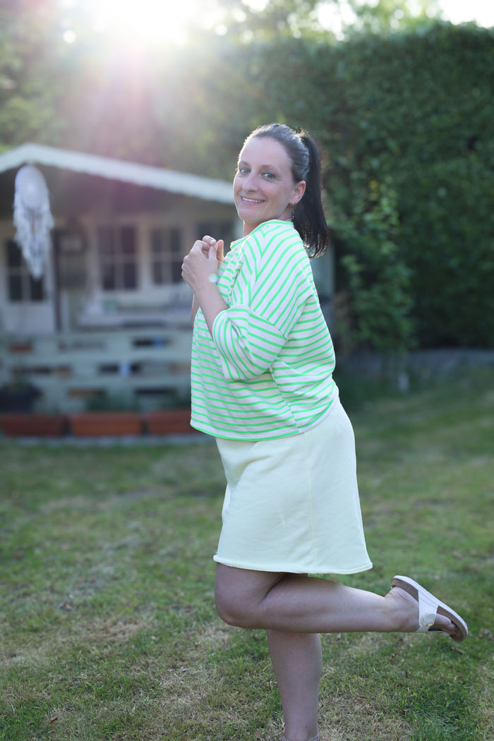 Lichte, losvallende top met frisgroene strepen op wit. Casual en comfy met halflange mouwen – perfect voor warme dagen.