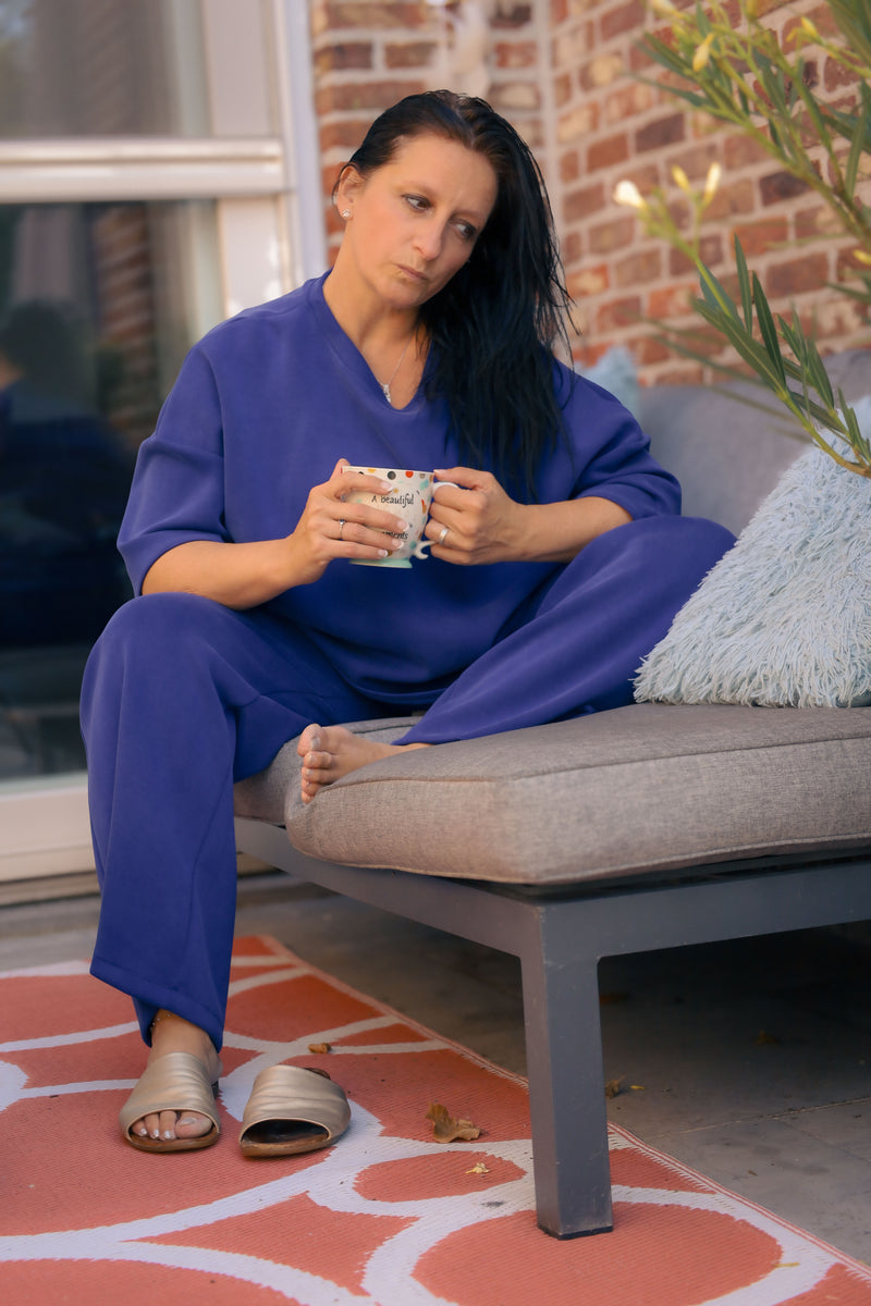 Vrouw poseert in kobaltblauwe  Dolci Giorni set met losse top en broek – comfortabele damesmode bij She&Me Duffel.