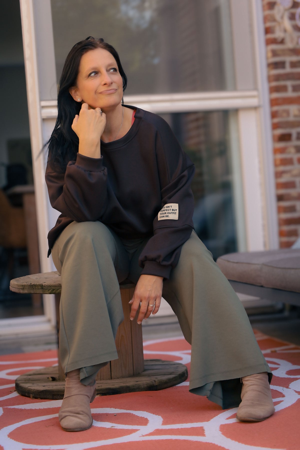 Vrouw draagt korte zwarte Dolci Giorni trui met losse pasvorm – damesmode bij She&Me Duffel.