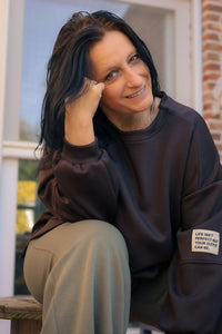 Vrouw draagt korte zwarte Dolci Giorni trui met losse pasvorm – damesmode bij She&Me Duffel.